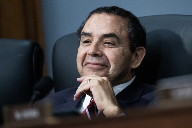 Representative Henry Cuellar sits and rests his hand on his chin