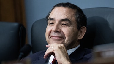Representative Henry Cuellar sits and rests his hand on his chin