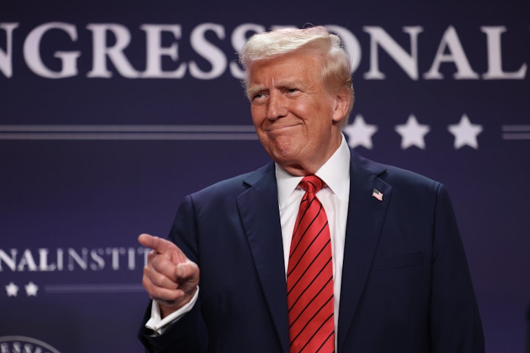Donald Trump smiles and points his finger (presumably to someone in the crowd, not pictured)