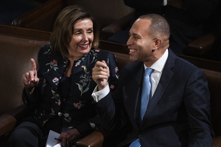 Nancy Pelosi looks at Hakeem Jeffries. Both are seated in the Capitol and laughing.