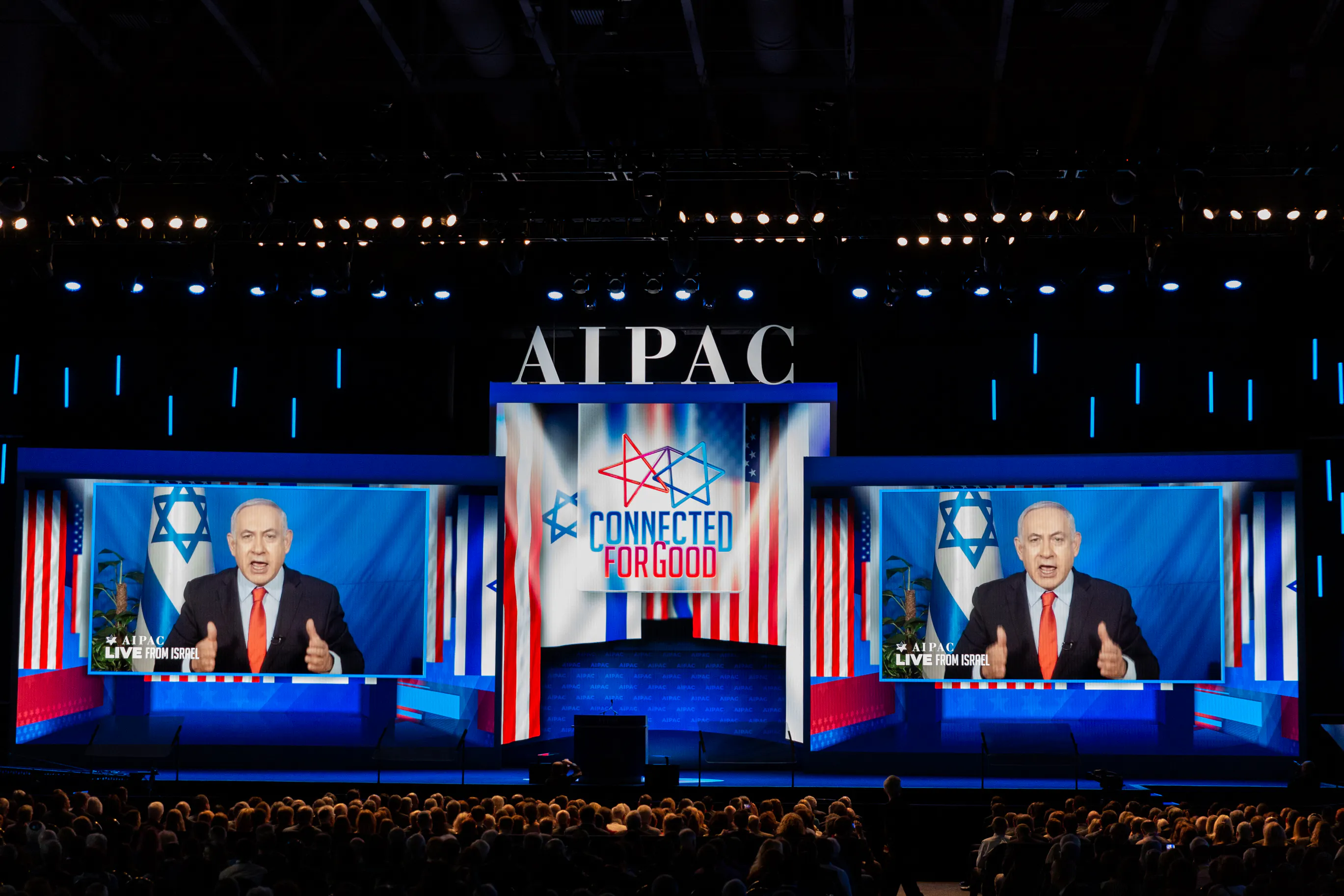 Israeli Prime Minister Benjamin Netanyahu speaks on two giant screens at the AIPAC conference.