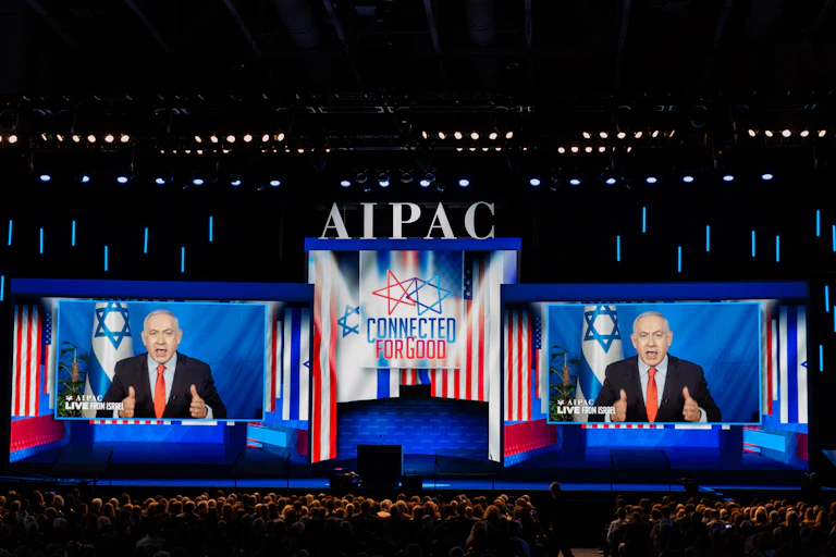 Israeli Prime Minister Benjamin Netanyahu speaks on two giant screens at the AIPAC conference.