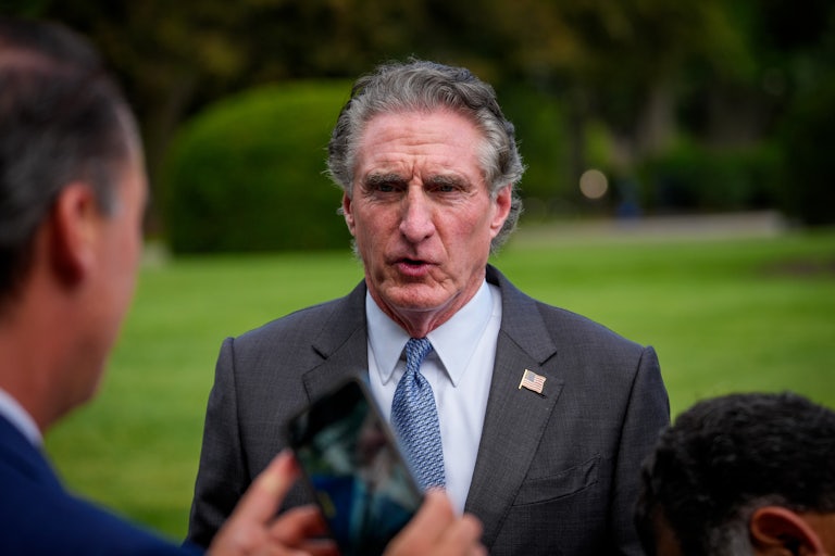 U.S. Interior Secretary Doug Burgum prepares for a television interview.