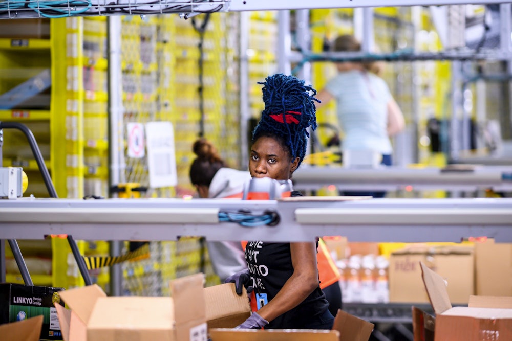 An Amazon warehouse worker loads boxes at a fulfillment center in Staten Island.