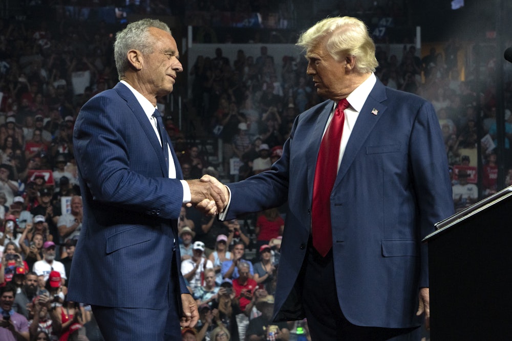 RFK Jr. and Donald Trump shake hands during a Trump campaign rally