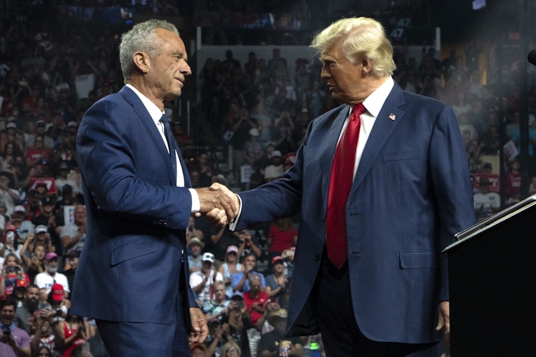 RFK Jr. and Donald Trump shake hands during a Trump campaign rally