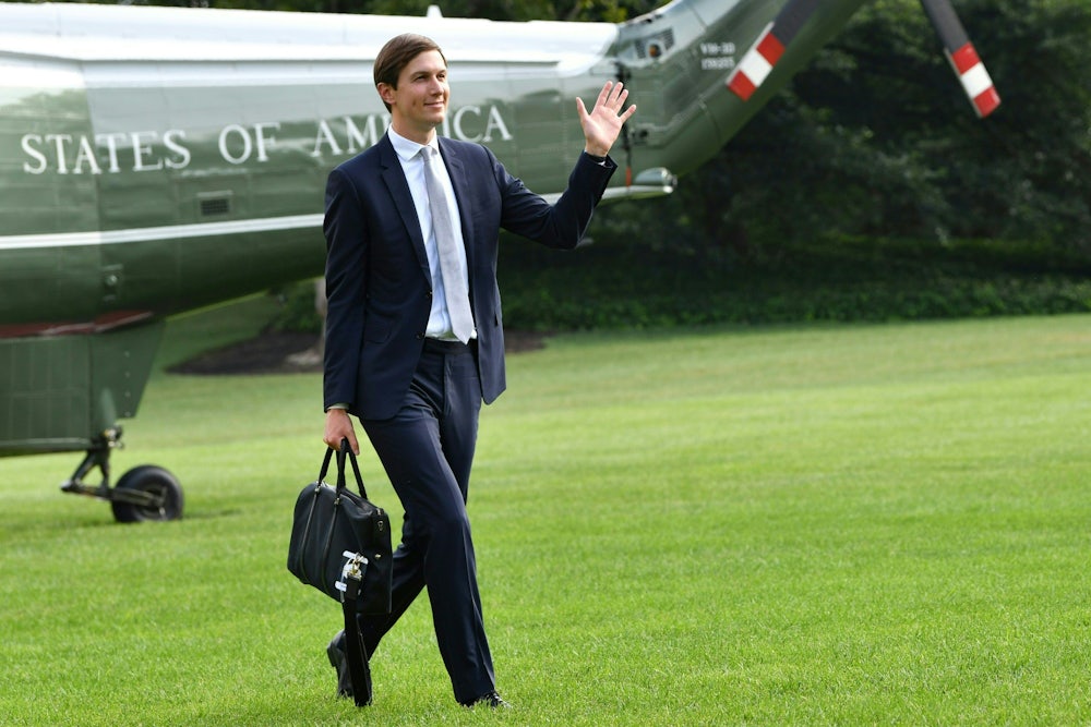 Jared Kushner waves as he returns to the White House