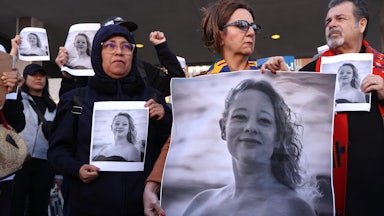 Protesters hold photos of Renee Nicole Good