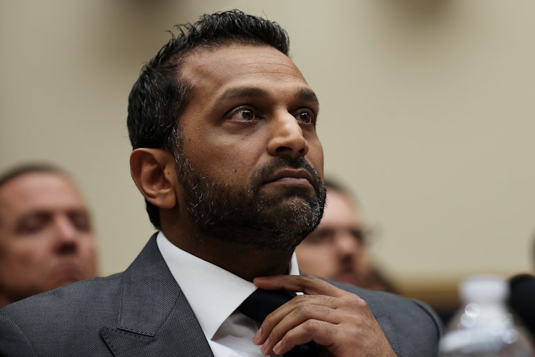 FBI Director Kash Patel fixes his tie while looking nervous