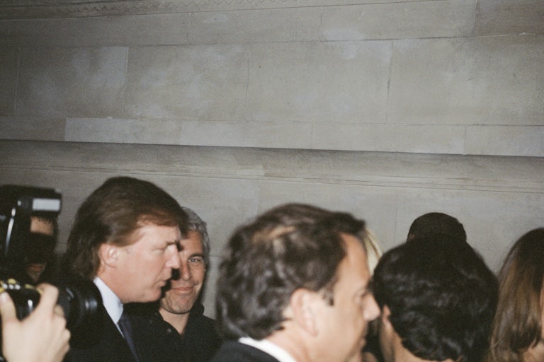 Donald Trump and Jeffrey Epstein stand in a crowd of people and papparazzi.