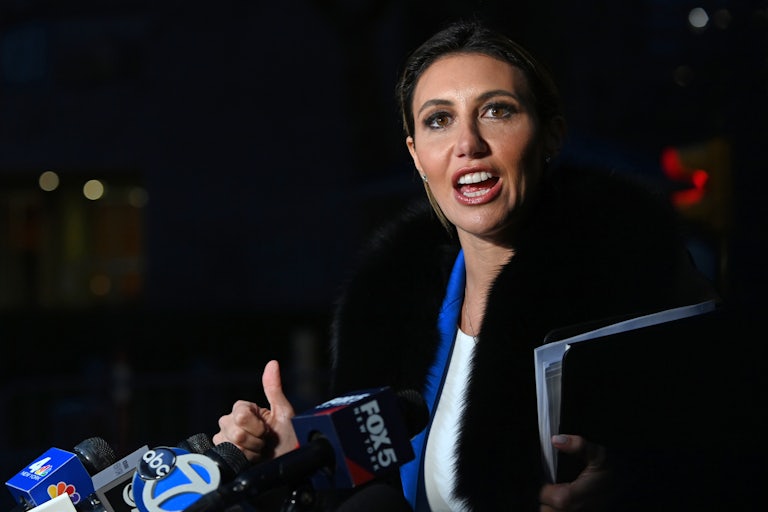 Alina Habba speaks into microphones