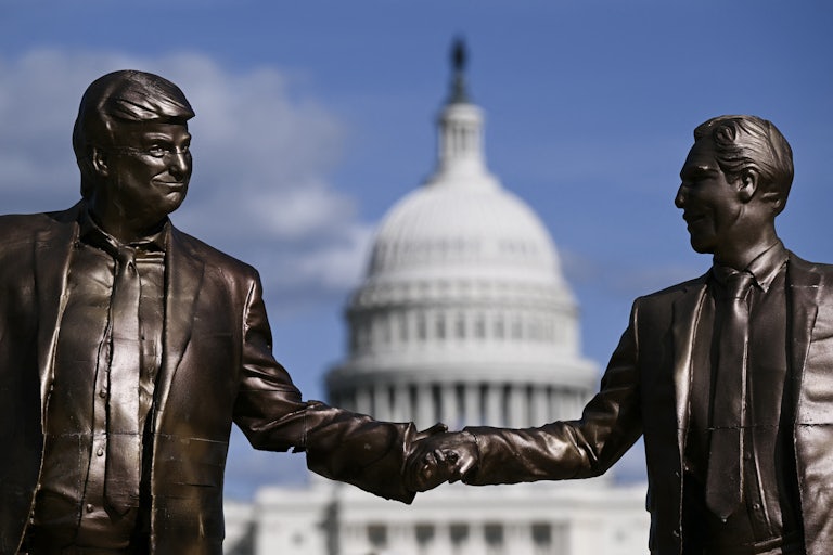 A statue of Donald Trump and Jeffrey Epstein holding hands stands in front of the Capitol