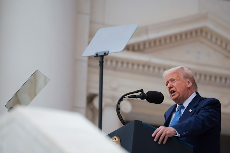 Donald Trump speaks at a podium during an event at Arlington National Cemetery