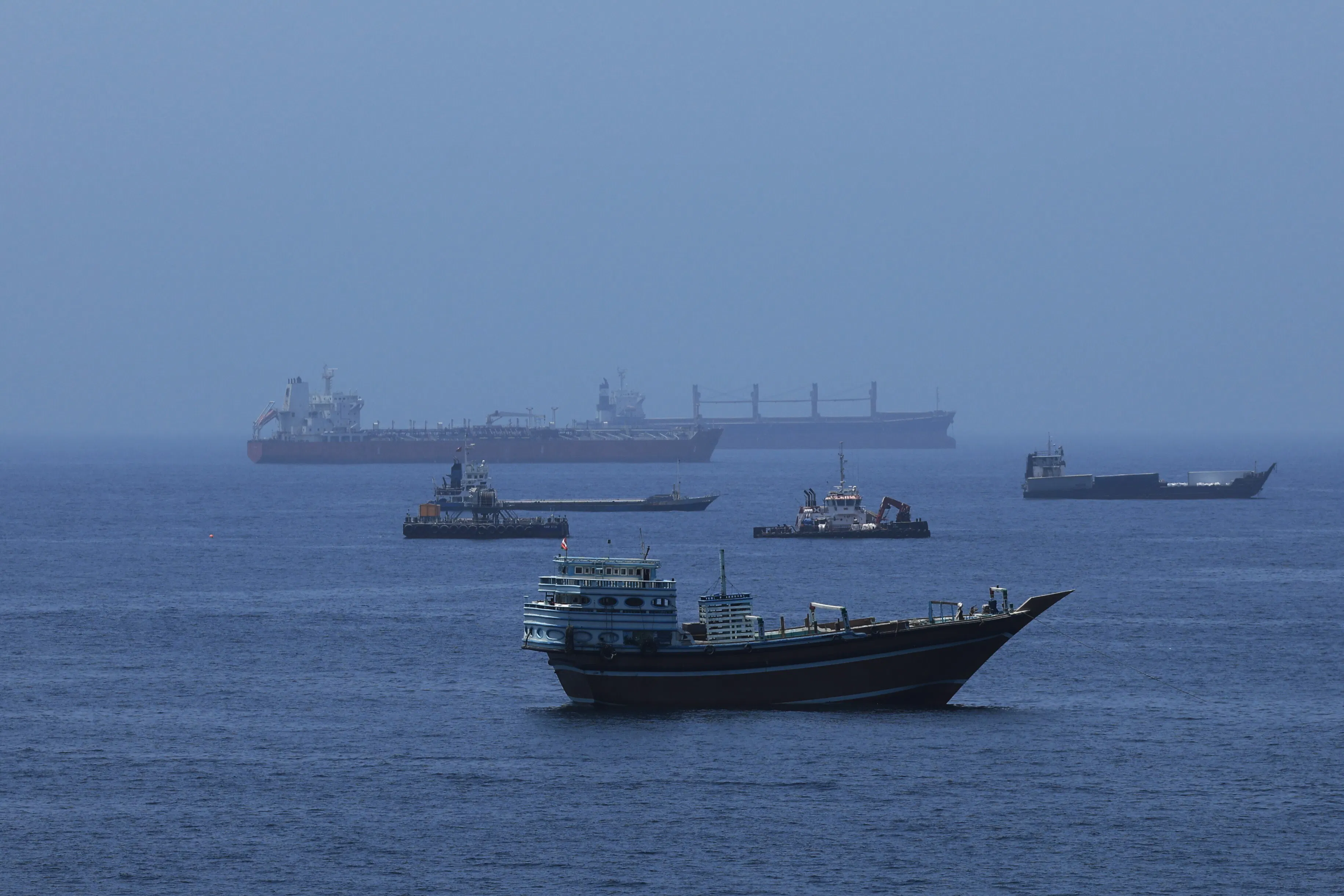 Commercial cargo vessels and crude oil tankers in the water