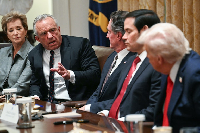 RFK Jr. speaks to Donald Trump during his Cabinet meeting. Doug Burgum and Marco Rubio sit between them, while Linda McMahon sits next to RFK Jr.