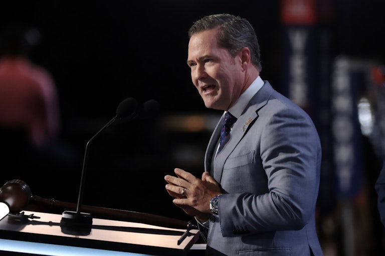 Representative Mike Waltz presses his hands together while speaking at the podium during the Republican National Convention