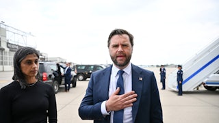 JD Vance speaks with a hand over his chest as his wife Usha zones out. The two are at an airport outside the plane.