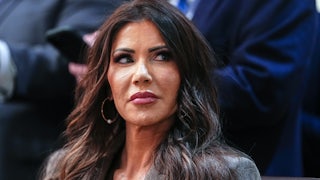 Homeland Security Secretary Kristi Noem looks to the side while sitting at an event