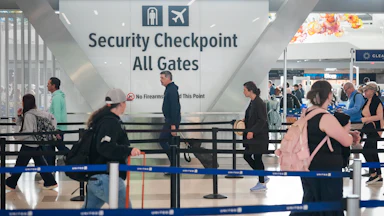 People walk in the TSA line at the George Bush Intercontinental Airport in Houston, Texas.