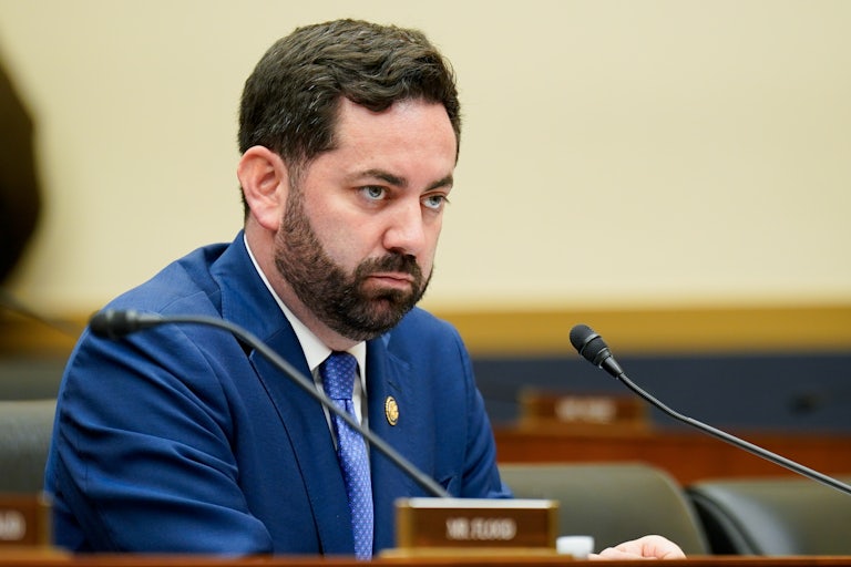 Representative Mike Lawler sits in a House committee hearing