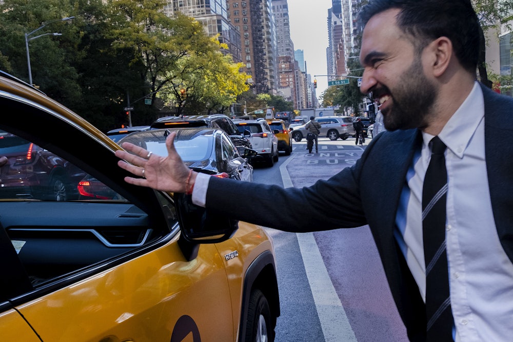 A photo of Zohran Mamdani shaking hands with a taxi driver