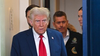 Donald Trump is trailed by Transportation Secretary Sean Duffy at a press conference in late January.