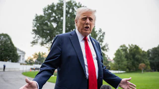 President Donald Trump speaks to members of the media on the South Lawn of the White House before boarding Marine One on September 30.