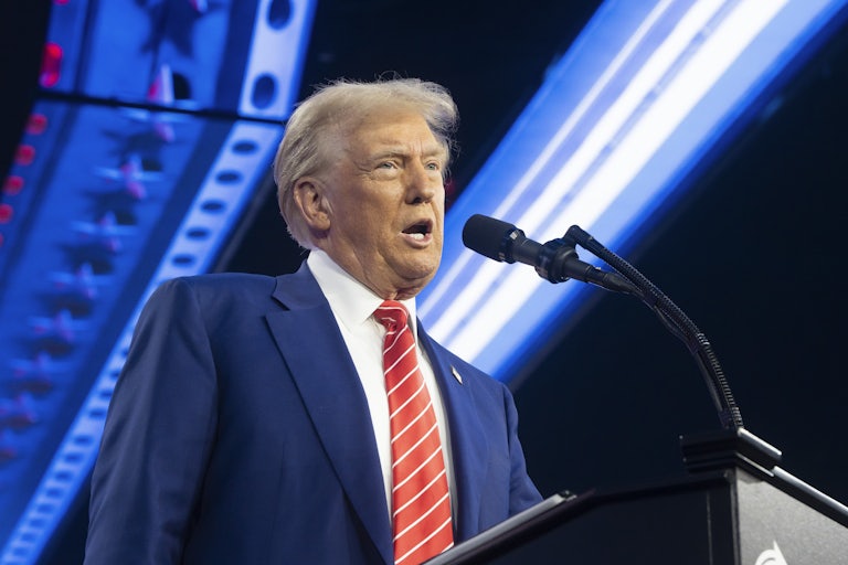 Donald Trump with mouth wide open at a lectern
