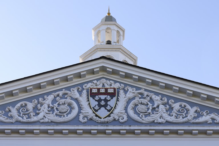 The Harvard crest on the front of the business school building