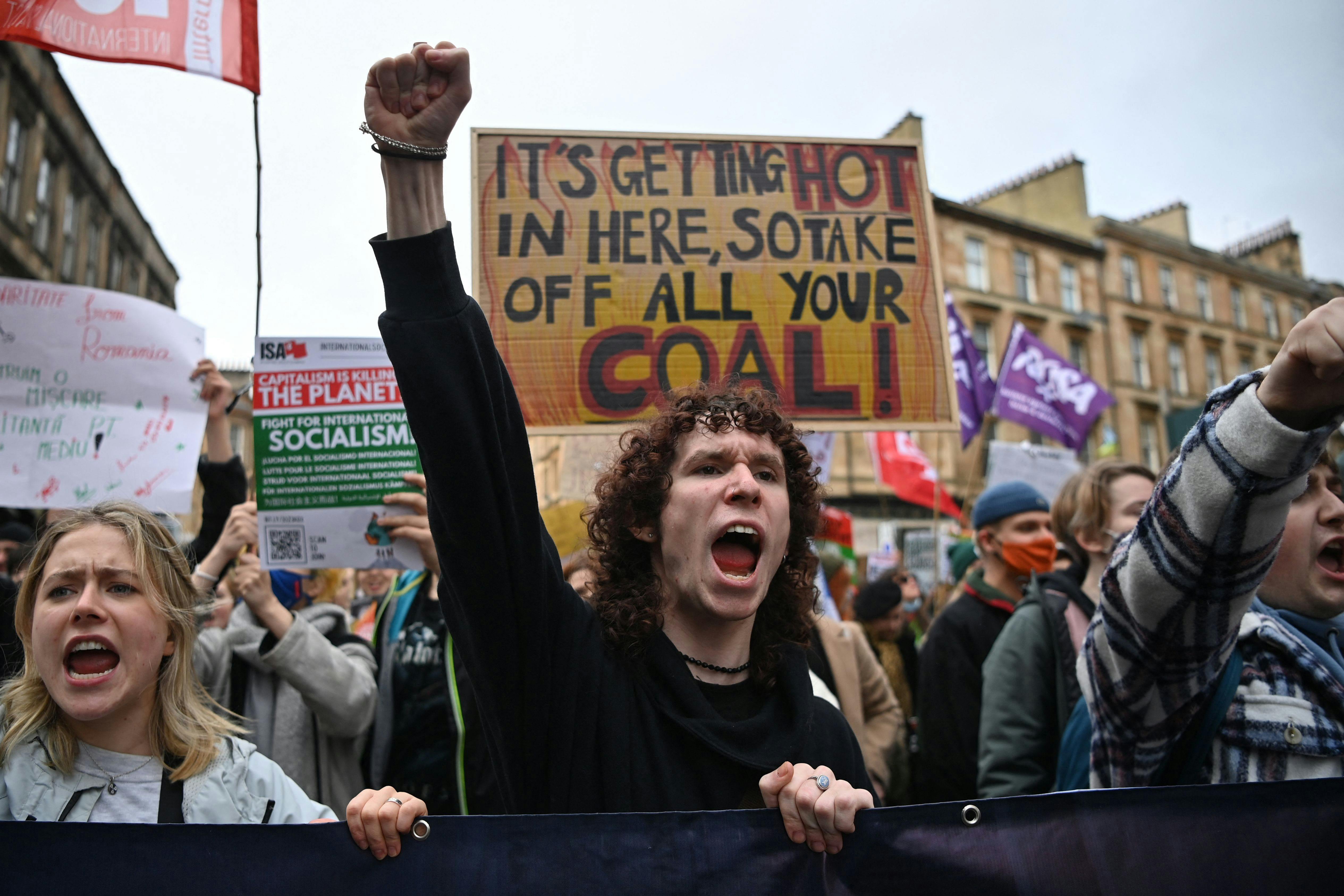 Youth activists shout with raised fists.