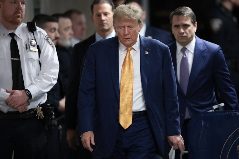 Donald Trump looks down as he walks