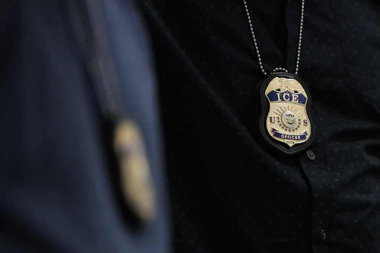 ICE agents wear their badges on a chain around their necks