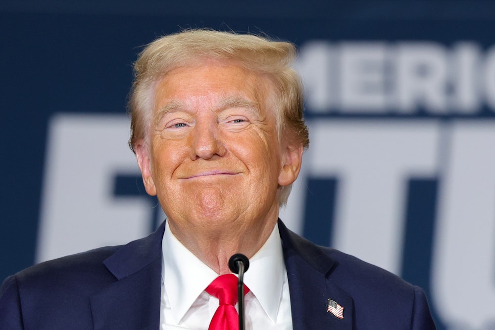 Former President Donald Trump smiles.