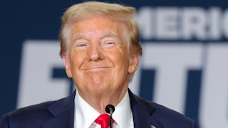Former President Donald Trump smiles.