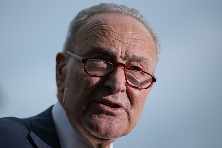 House Minority Leader Chuck Schumer wears his glasses and speaks.