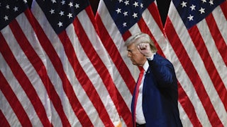Donald Trump raises his fist as he leaves after speaking during a campaign rally in North Carolina.