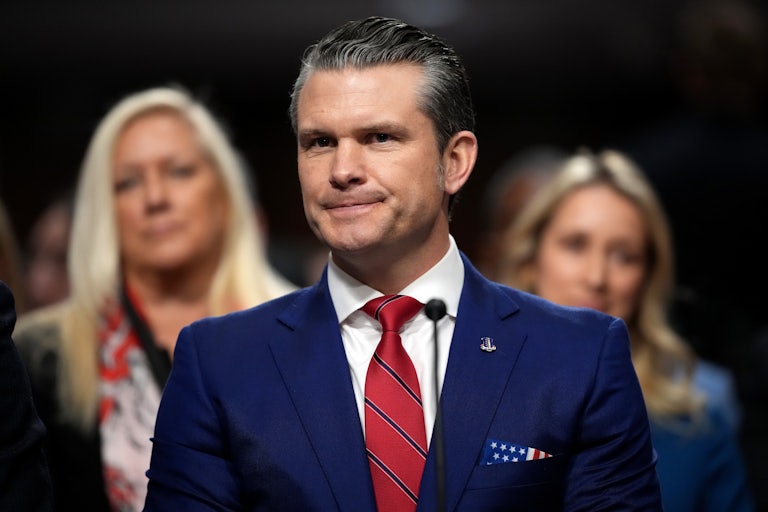 Pete Hegseth purses his lips while testifying before the Senate