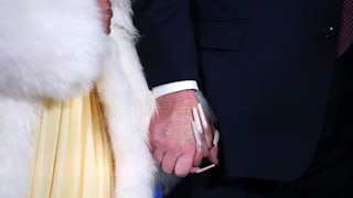 Close-up of Nicki Minaj and Donald Trump holding hands, with Nicki’s long nails and the concealer on Trump’s hand