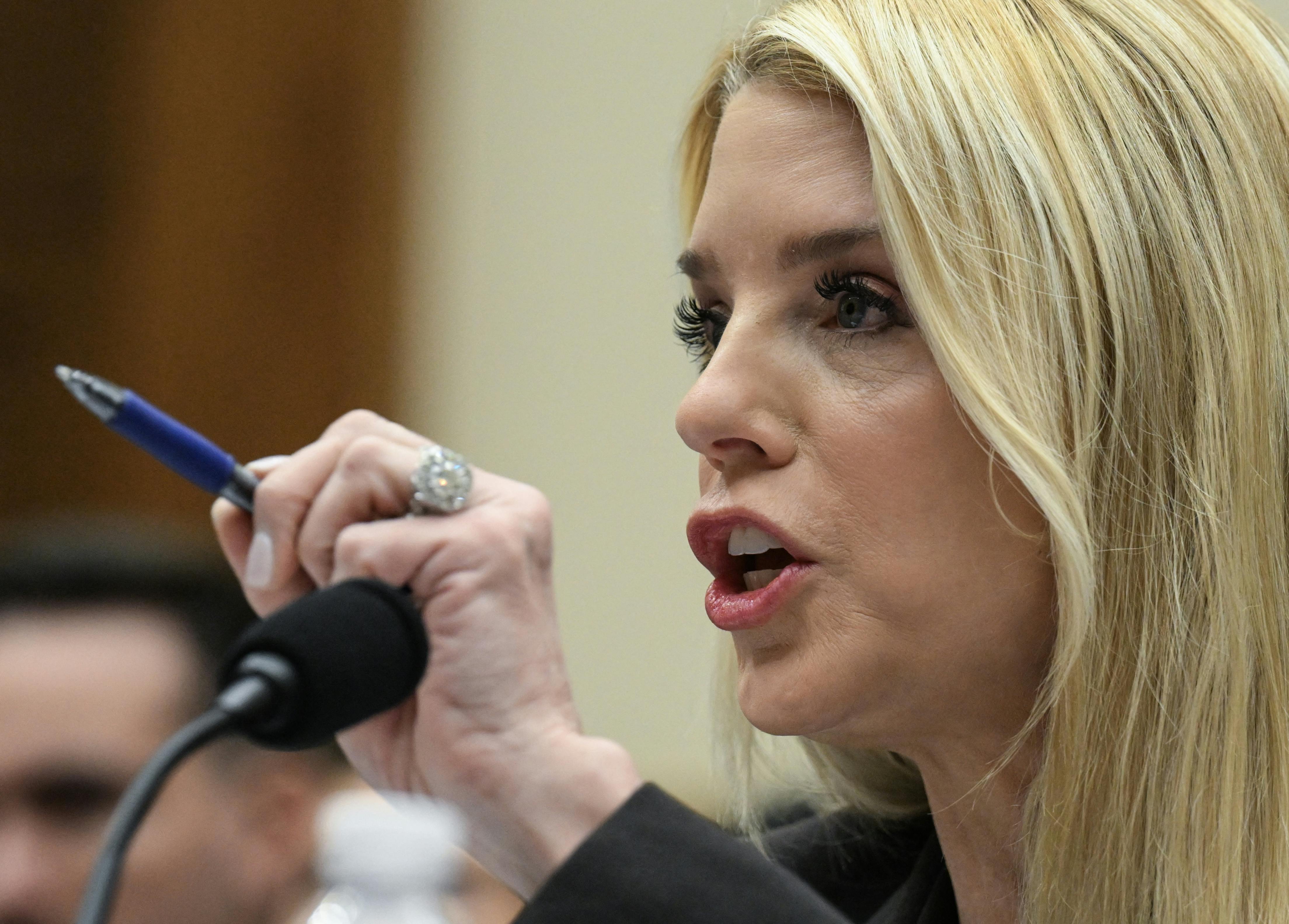 Attorney General Pam Bondi uses a pen to point while speaking during a House hearing