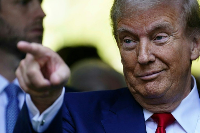 Donald Trump points while at a 9/11 memorial