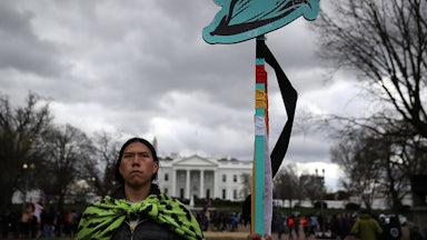 A protester holds a sign during a demonstration against the Dakota Access Pipeline in Washington, D.C., in 2017.