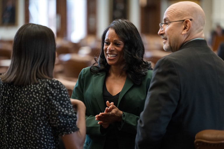 Texas Democratic Representative Nicole Collier speaks with colleagues.