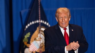 Donald Trump clasps both hands