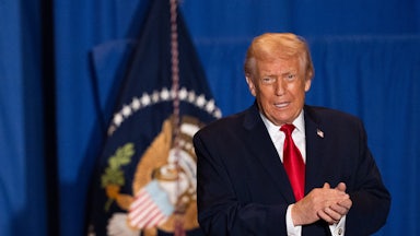 Donald Trump clasps both hands