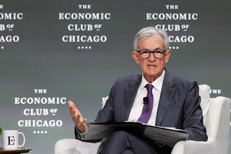 Federal Reserve Chair Jerome Powell gestures and speaks while sitting onstage at the Economic Club of Chicago