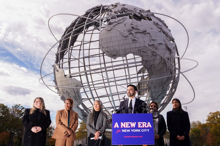 Zohran Mamdani speaks to reporters alongside his transition team, from left, Elana Leopold, Melanie Hartzog,Maria Torres-Springer, Grace Bonilla, and Lina Khan, at Flushing Meadows Corona Park.