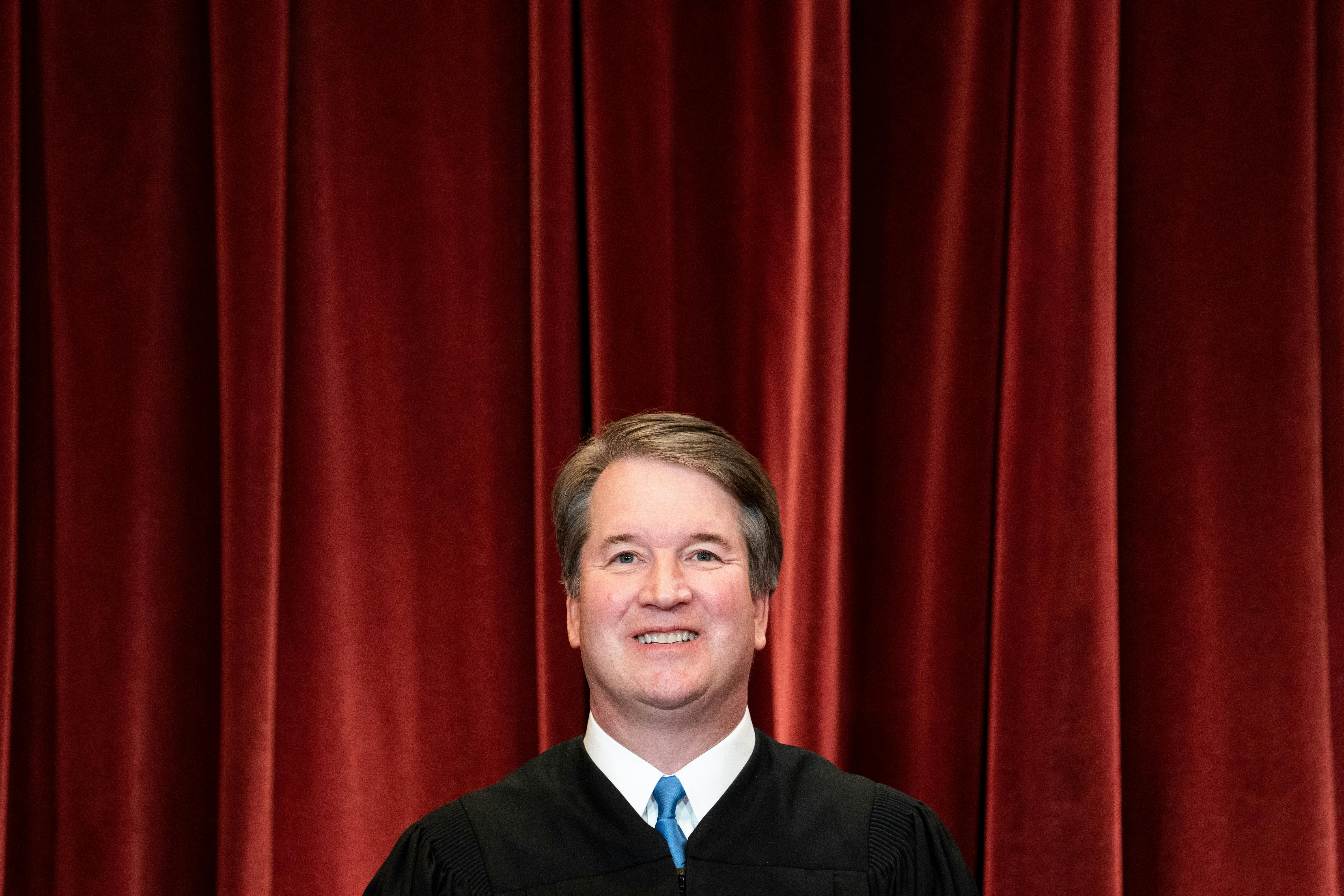 Associate Justice Brett Kavanaugh stands during a group photo of the Justices at the Supreme Court.