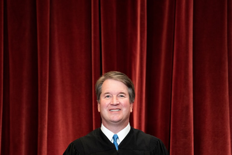 Associate Justice Brett Kavanaugh stands during a group photo of the Justices at the Supreme Court.