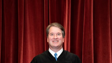 Associate Justice Brett Kavanaugh stands during a group photo of the Justices at the Supreme Court.