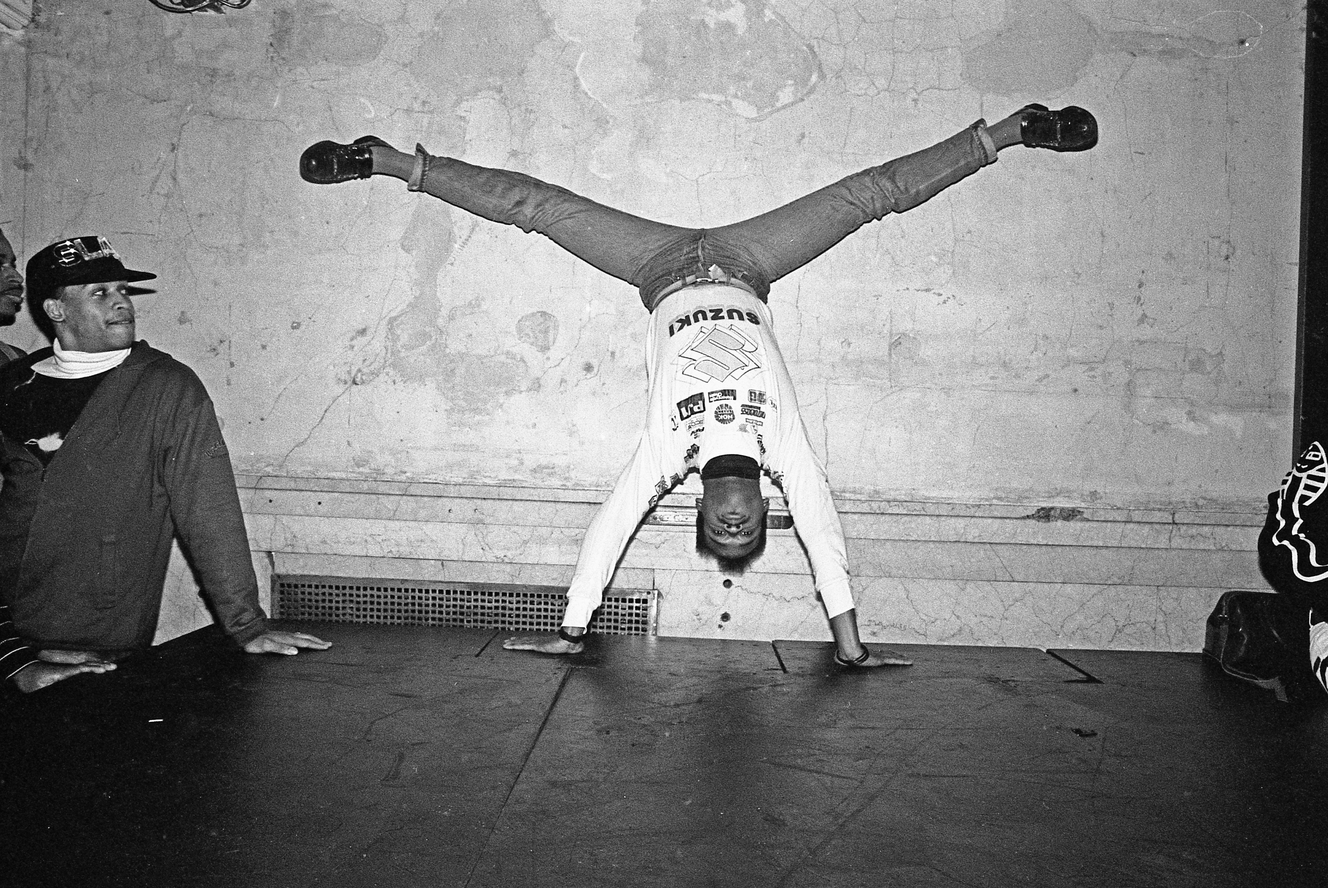 Dancer wearing jeans and a sweater upside down, voguing at the nightclub Mars in 1988 in New York City.